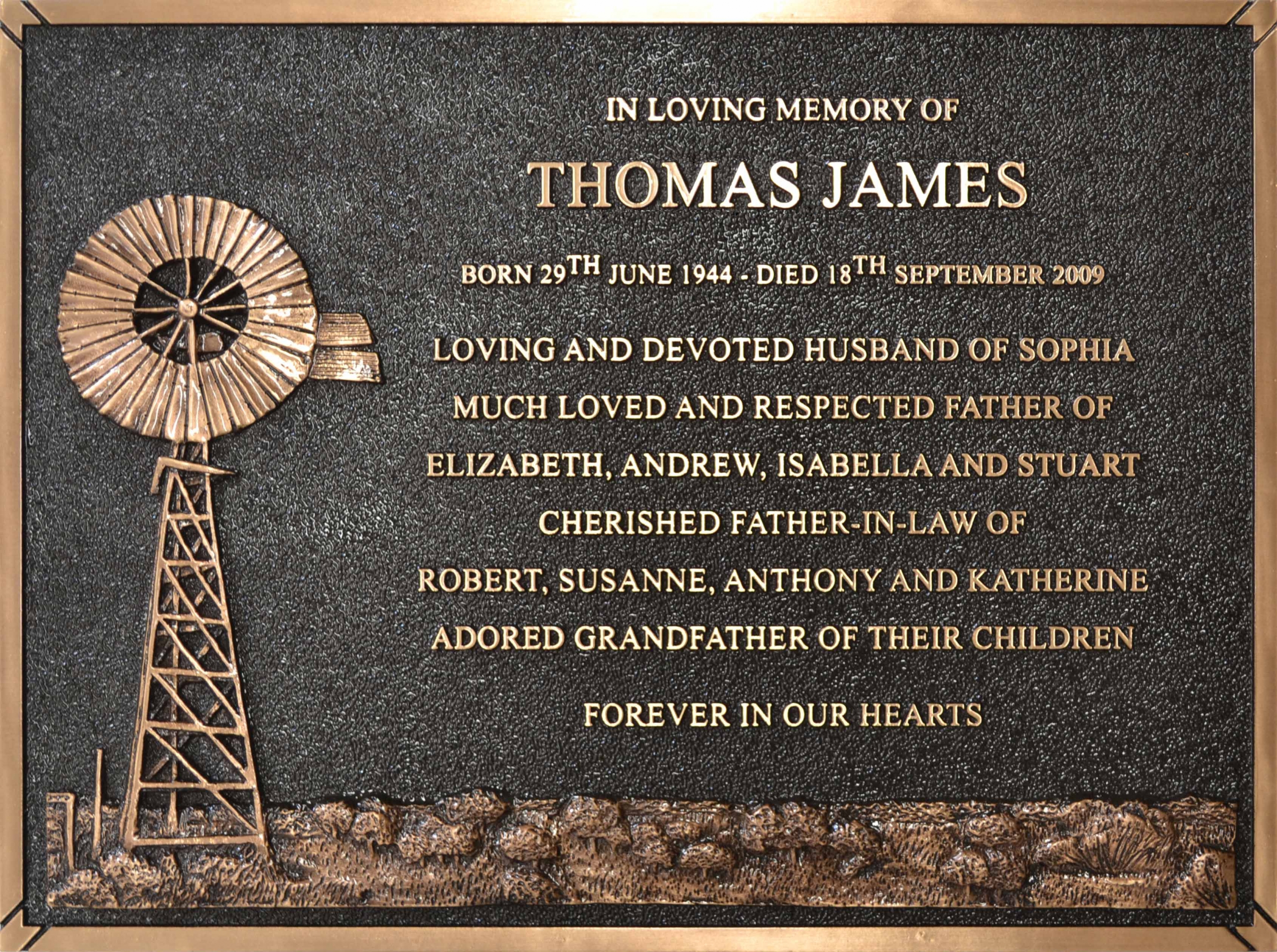 Cast bronze memorial plaque with windmill motif and raised bronze lettering
