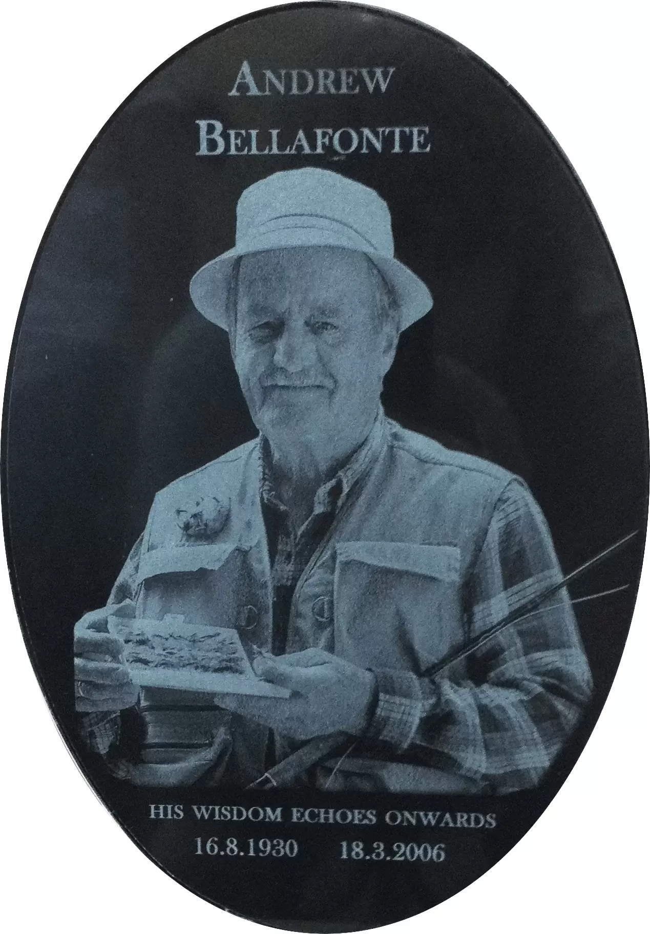 Oval laser etched stone portrait of a man in a hat, etched at photographic quality by Forever Shining