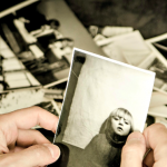 Man Looking at Photo of child