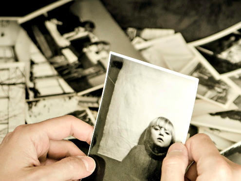 Man Looking at Photo of child