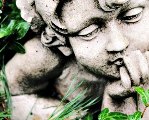 Cherub Statue In Grass