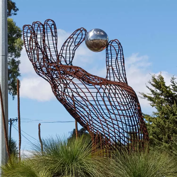Carers of Everything corten and stainless steel hand sculpture on Spearwood Avenue, City of Cockburn